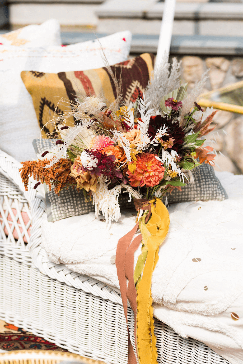 A rustic bouquet of flowers placed on a piece of furniture