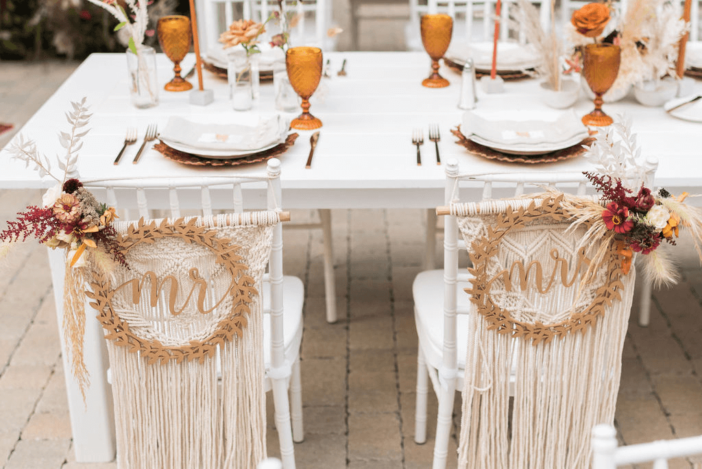 The bride and grooms chairs read "mr" and "mrs" 