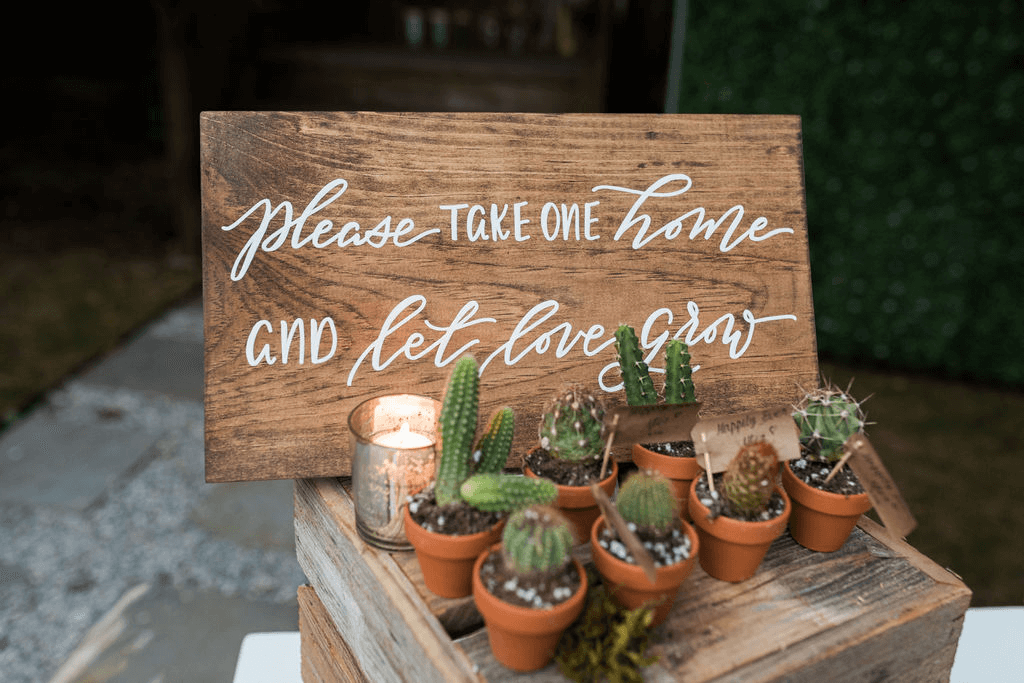 a sign telling guests to take a succulent home