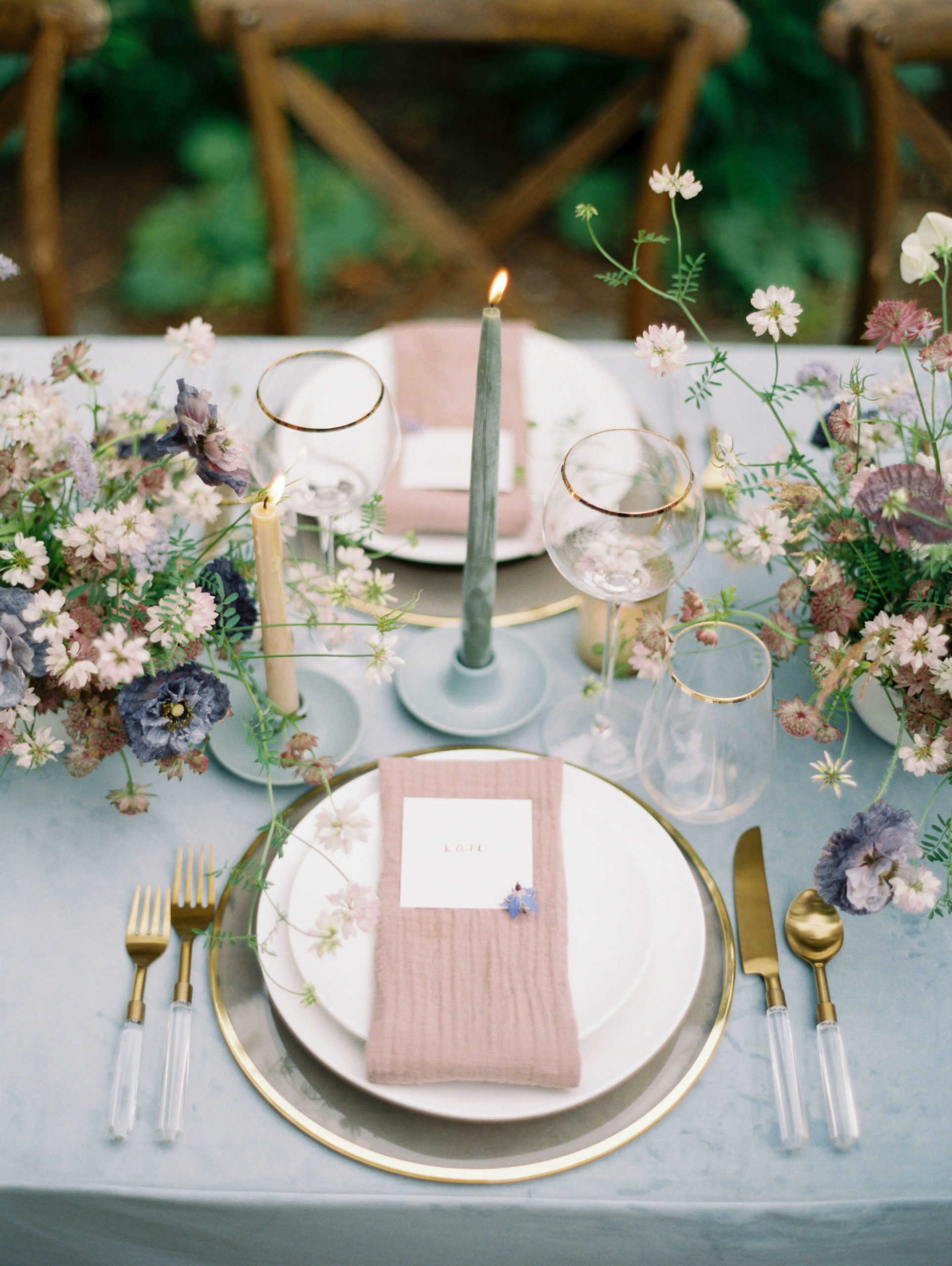 flowers, candles, and plates for the table setting of a New York wedding