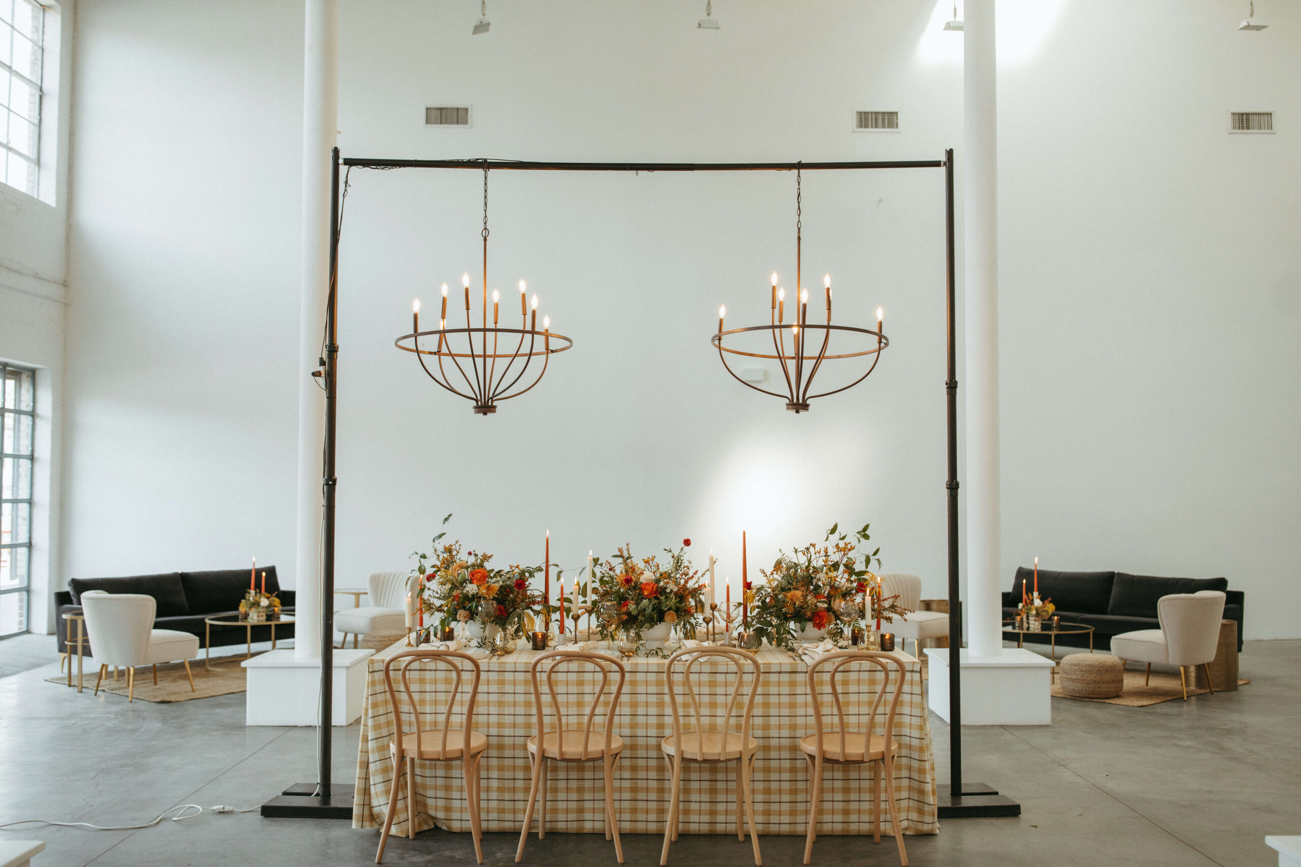 A rustic table setting framed by two lounges at a NYC wedding venue