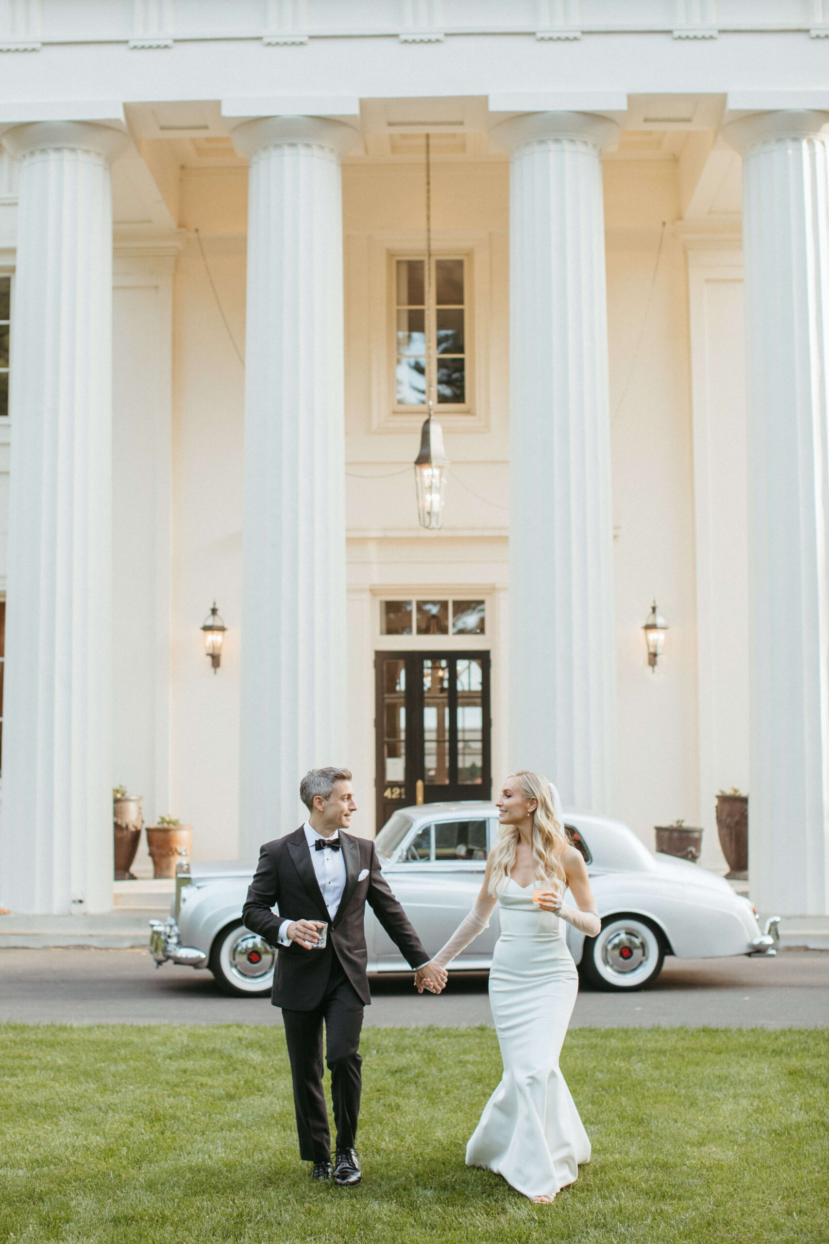 Bride and groom holding hands.