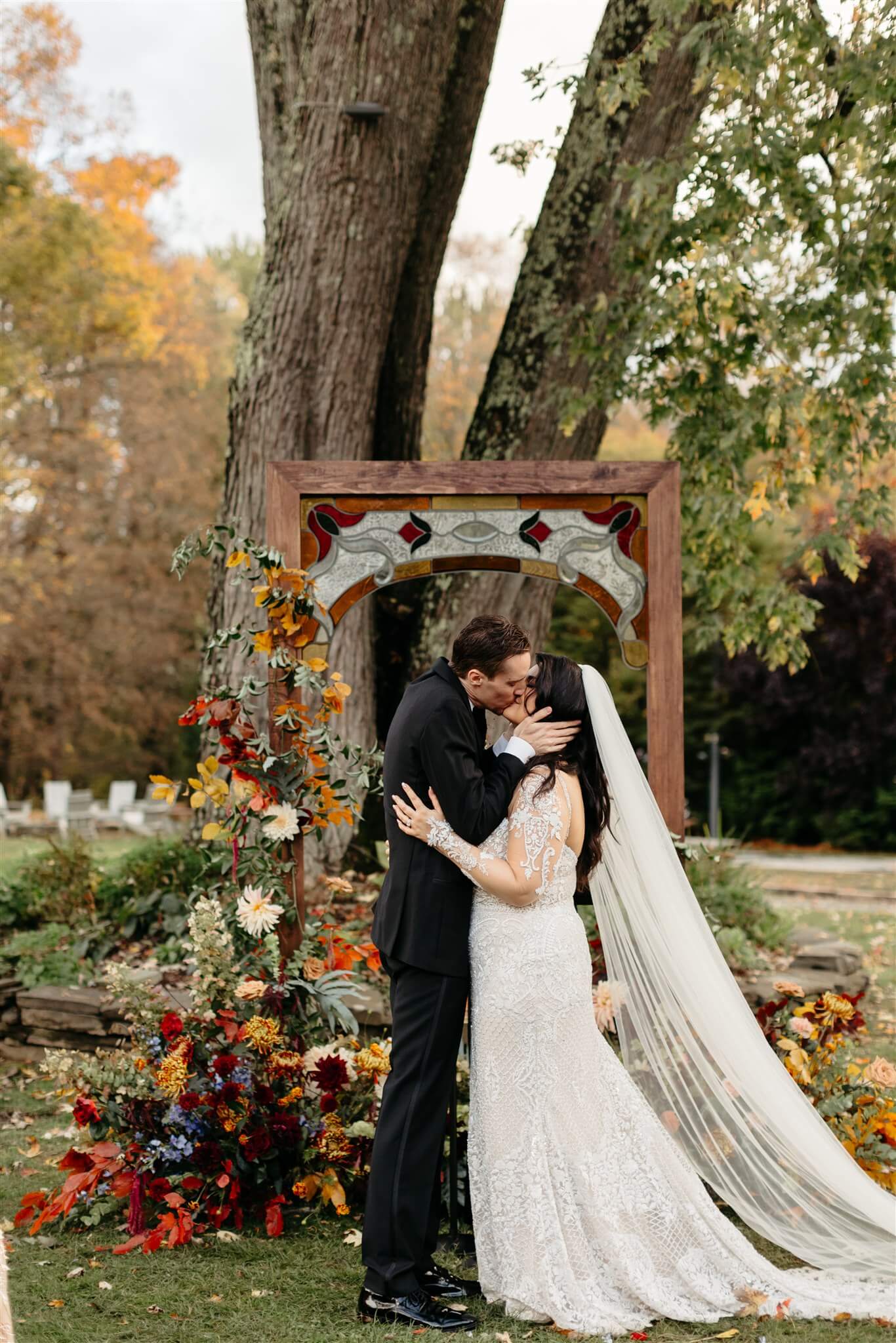 Bride and groom kiss during the fall themed wedding in the Hudson Valley
