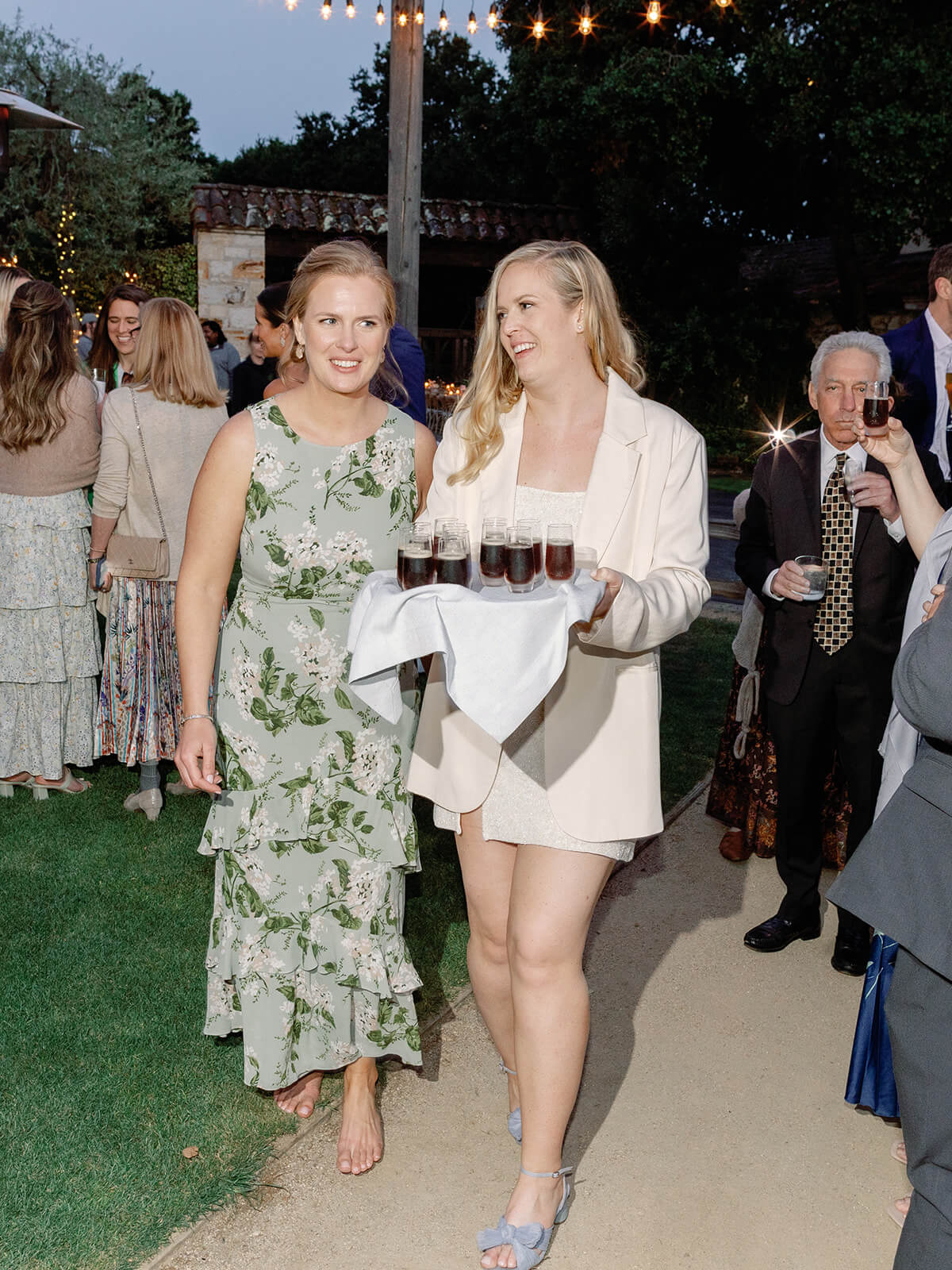 Bride carries serving platter of cold brew during destination wedding in California